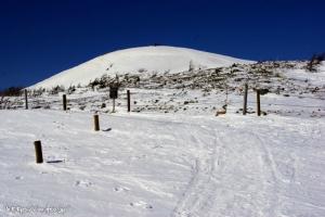 白根山　湯釜。なだらかな丘のてっぺんにスキーをつけた人々の集団が見える。